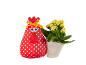 Red polka dot chicken and yellow potted flowers on a black background.