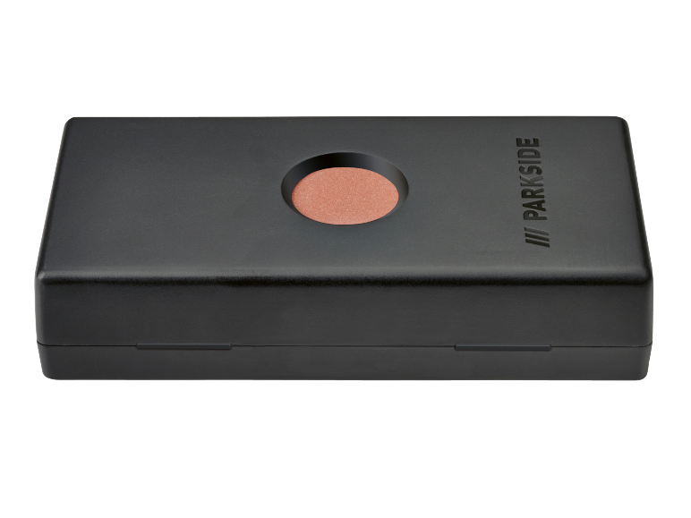 Black sharpening stone with an orange abrasive wheel and an embossing on the lid