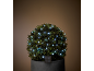Decorative bush with solar-powered LED lights in a dark room.