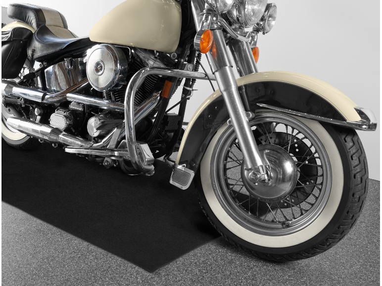 Close-up of a classic motorcycle with a beige tank and chrome details.