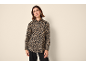 Woman in a leopard print shirt and black trousers.