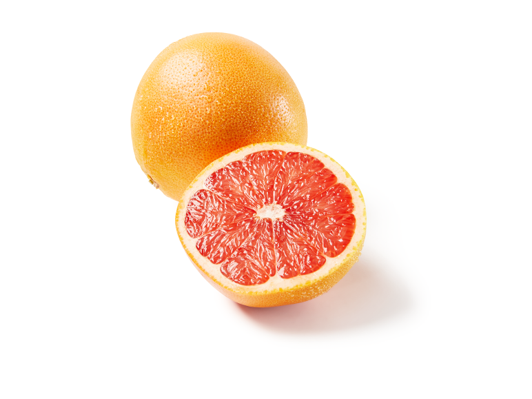 Whole and half red grapefruit with water droplets
