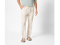 Man wearing light green t-shirt, beige linen trousers, and light sandals.