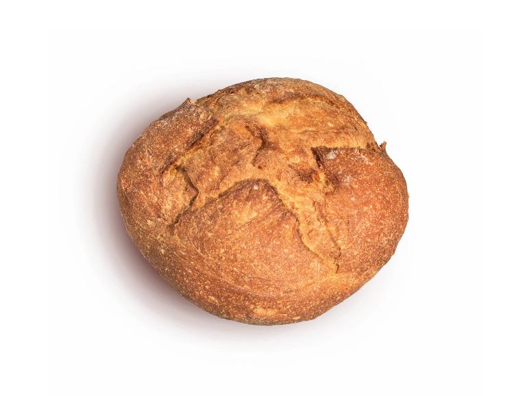 Round sourdough bread with a crispy crust, viewed from above.