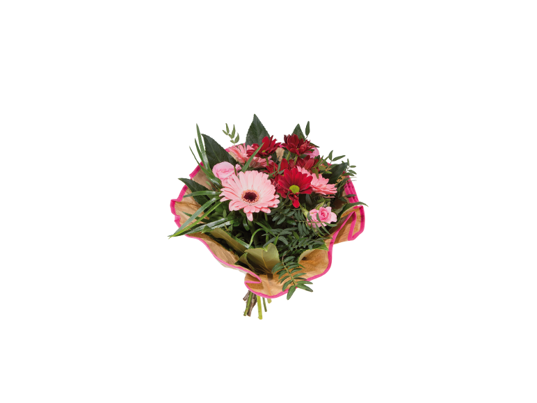 Bouquet of pink and red mixed flowers with gerberas and chrysanthemums, wrapped in brown paper.