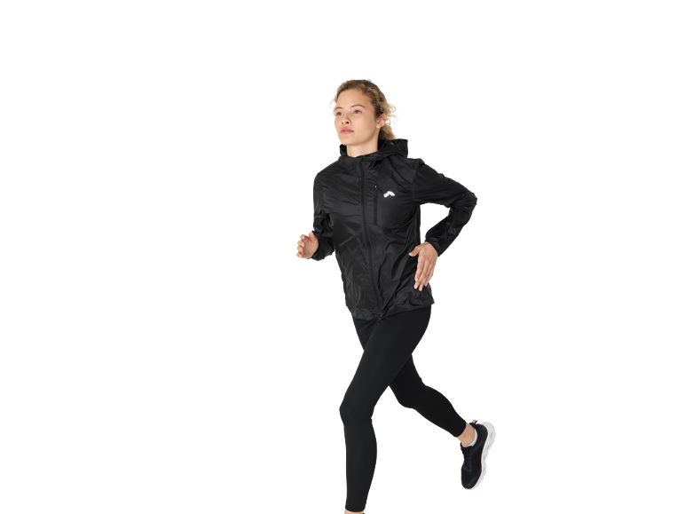 Woman running in a black running jacket and black leggings.