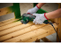 Person in gloves sanding a wooden bench with a multi-tool.