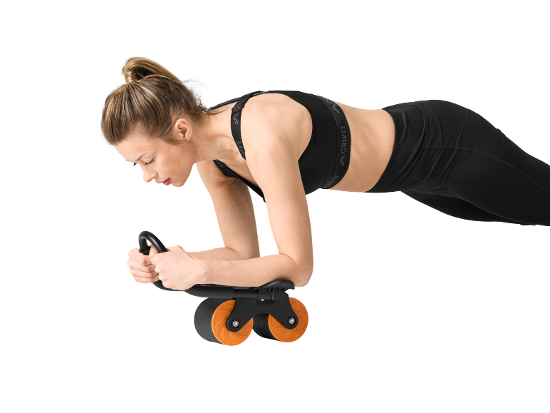 Woman in black sports bra and leggings doing a plank exercise with an ab roller.
