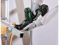 Cordless reciprocating saw cutting metal, held by hands in work gloves