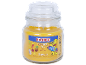 Yellow scented candle in a glass jar with a 'Tropical Fun' label and a surfing bear.