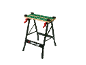 Work bench with a green patterned surface and red handles.