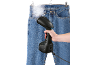 Handheld garment steamer smoothing wrinkles from a pair of jeans.