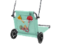 Beach trolley with sand toys in a mesh pocket.