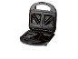 Open black sandwich maker with triangular plates on a black background.