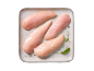 Raw chicken fillets on a plate, seasoned with pepper and sage.