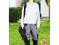 Person holding a leaf blower, wearing work trousers and a sweatshirt, with a shoulder strap.