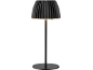 Black table lamp with a pleated shade and round base, illuminated.