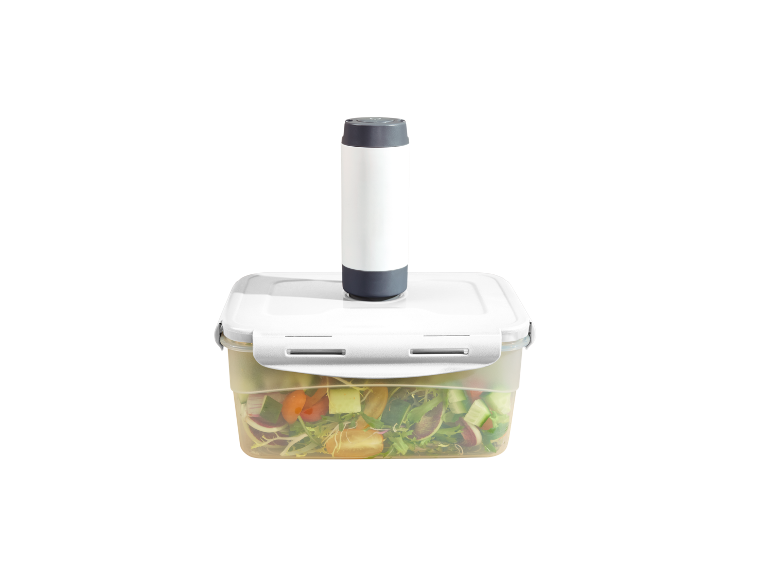 Vacuum pump on a food container with salad.