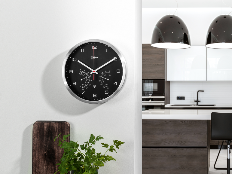 Wall clock with thermometer and hygrometer in a modern kitchen.