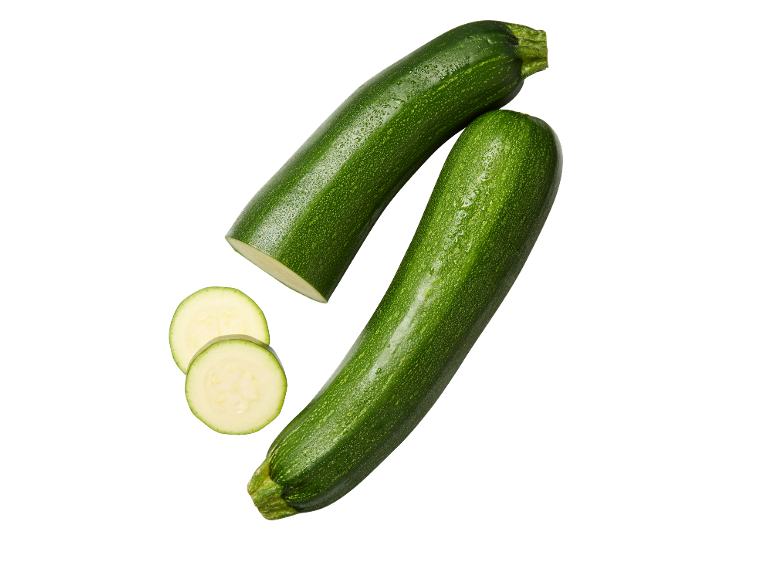 Fresh green zucchini, whole and sliced, on a black background.