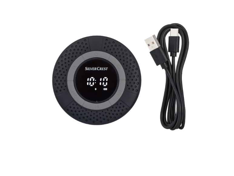 Round Bluetooth speaker with time display and USB charging cable.