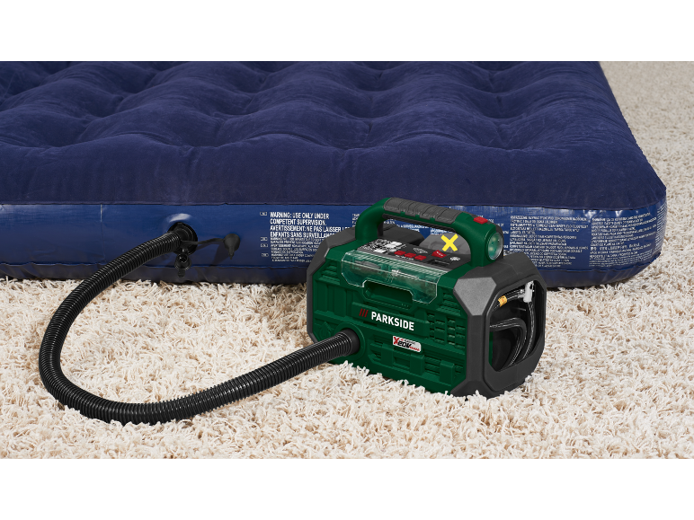 Air mattress being inflated by an electric pump on a beige carpet.