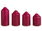 Four cherry-colored pillar candles in decreasing sizes