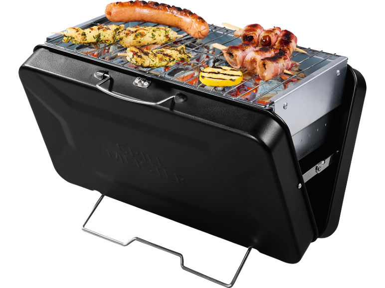 Portable grill with grate, sausage, chicken skewers, bacon, and lemon.