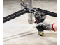 Cordless impact driver fastens metal construction to concrete floor.
