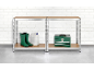 Metal shelving units with garden boots, a jerrycan, and a toolbox.