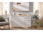 White sideboard with wooden top, decorated with vases and an olive plant.