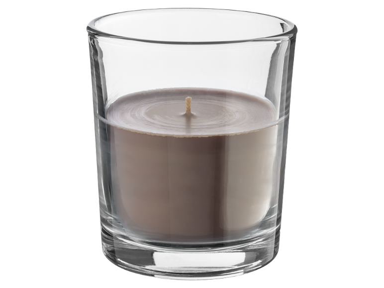 Light brown candle in a glass with an unlit wick.