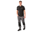 Man in black polo shirt with logo and grey work trousers.