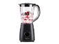 Black blender with a clear jug filled with yogurt and berries.
