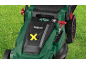 Green lawnmower with a yellow 'X' symbol and height adjustment lever on green grass.