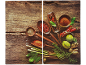 Spices and herbs like chilies, limes, ginger, and rosemary on wood.