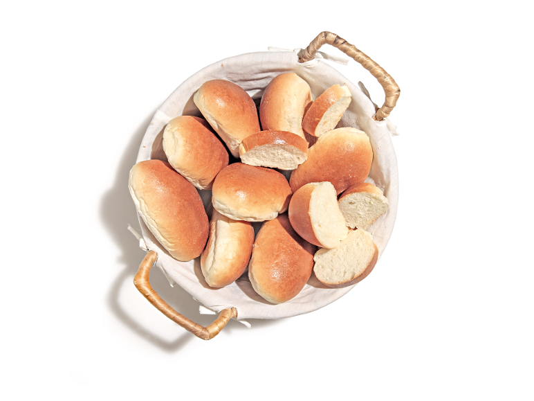 Basket of golden rolls, some cut in half.