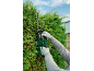 Trimming a hedge with an electric hedge trimmer