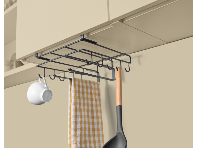 Under-cabinet kitchen organizer with a mug, towel, and ladle.