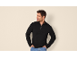 Man in black zip-up sweatshirt and jeans