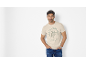 Man in a beige t-shirt with a turtle print and the inscription «Turtle Cove Island Resort».