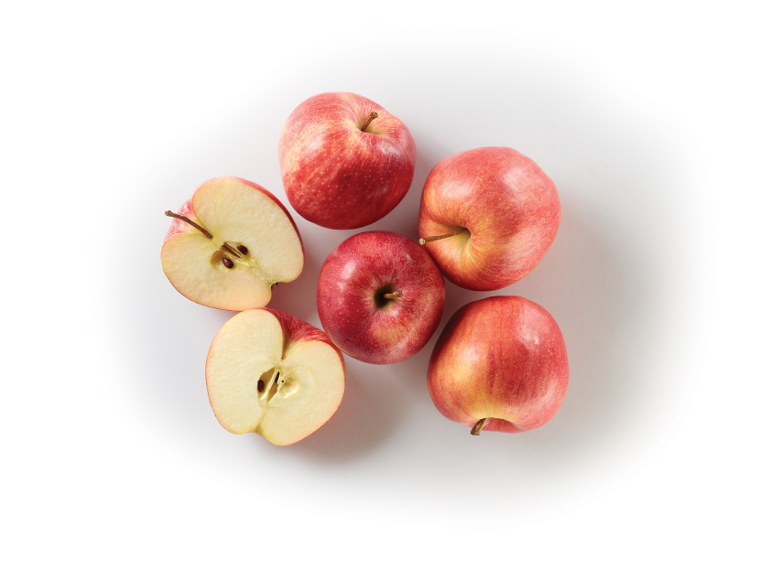 Red apples, whole and halved, on a white background.