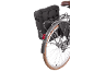 Black bicycle bag with reflective details, red rear light, and wheel with brown tire.
