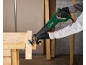 Electric reciprocating saw cutting wood on a workbench