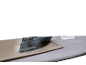 Steam iron on an ironing board with a resting pad and a water bottle.