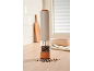 Electric salt and pepper grinders with wooden base and peppercorns in the kitchen.