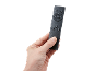 Hand holding a black remote control with play control and fan buttons.