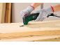 Multi-tool removing a nail from a wooden board, hands in protective gloves.
