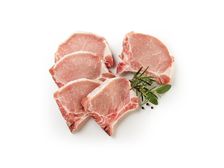 Fresh pork chops with rosemary, sage, and peppercorns on a white background.