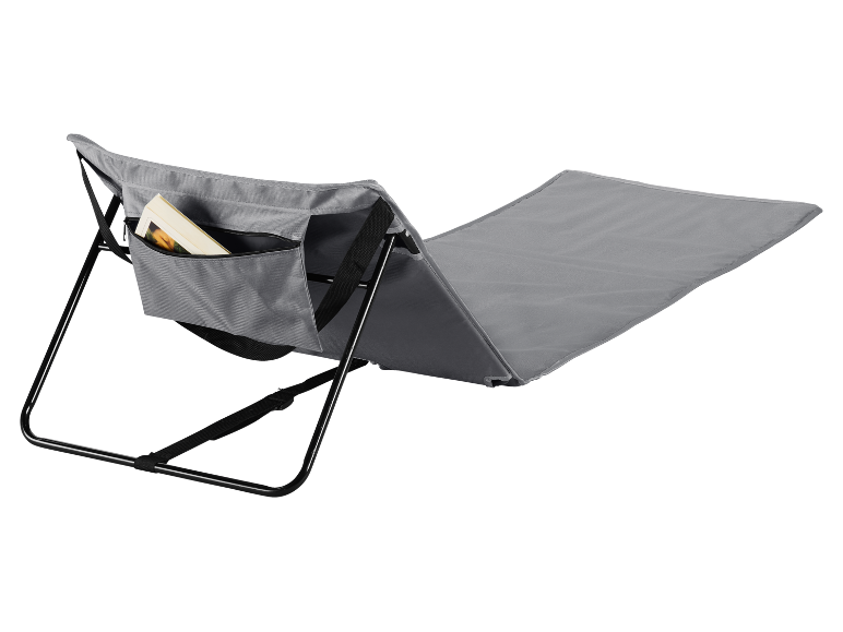 Grey folding lounge chair with a side pocket containing a book.
